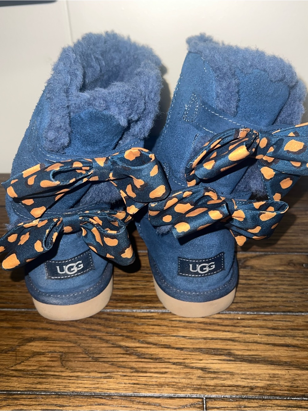 UGG Kids Navy Suede Bow Back Booties with Orange Print